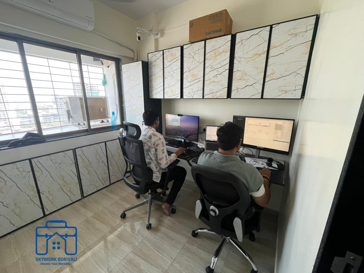 Members working at dual monitor setups in the open workspace